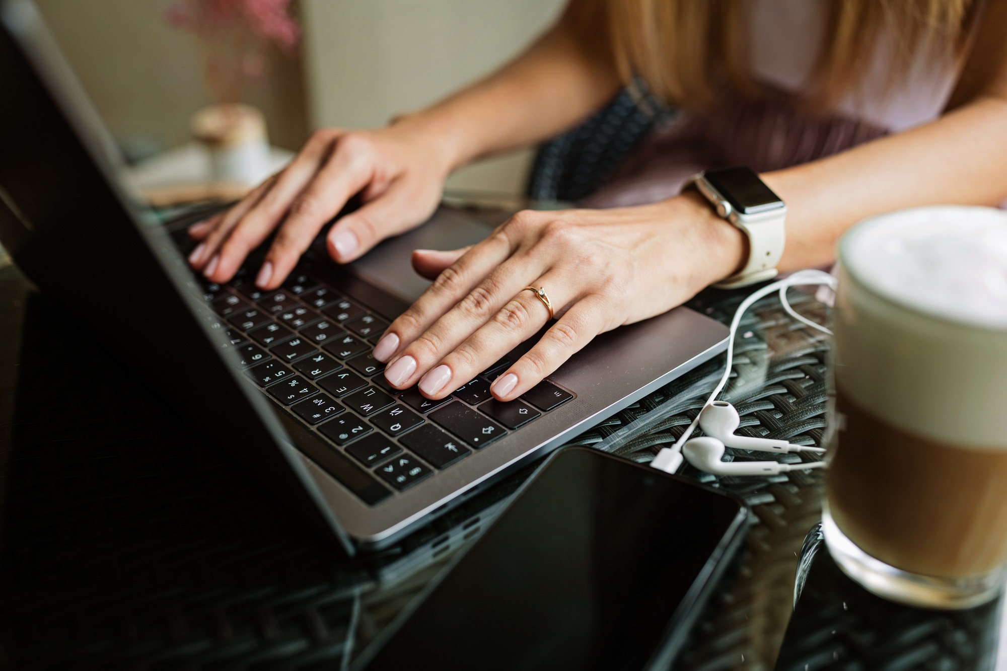 Business woman working online on laptop from home or cafe during coronavirus Covid-19 pandemic