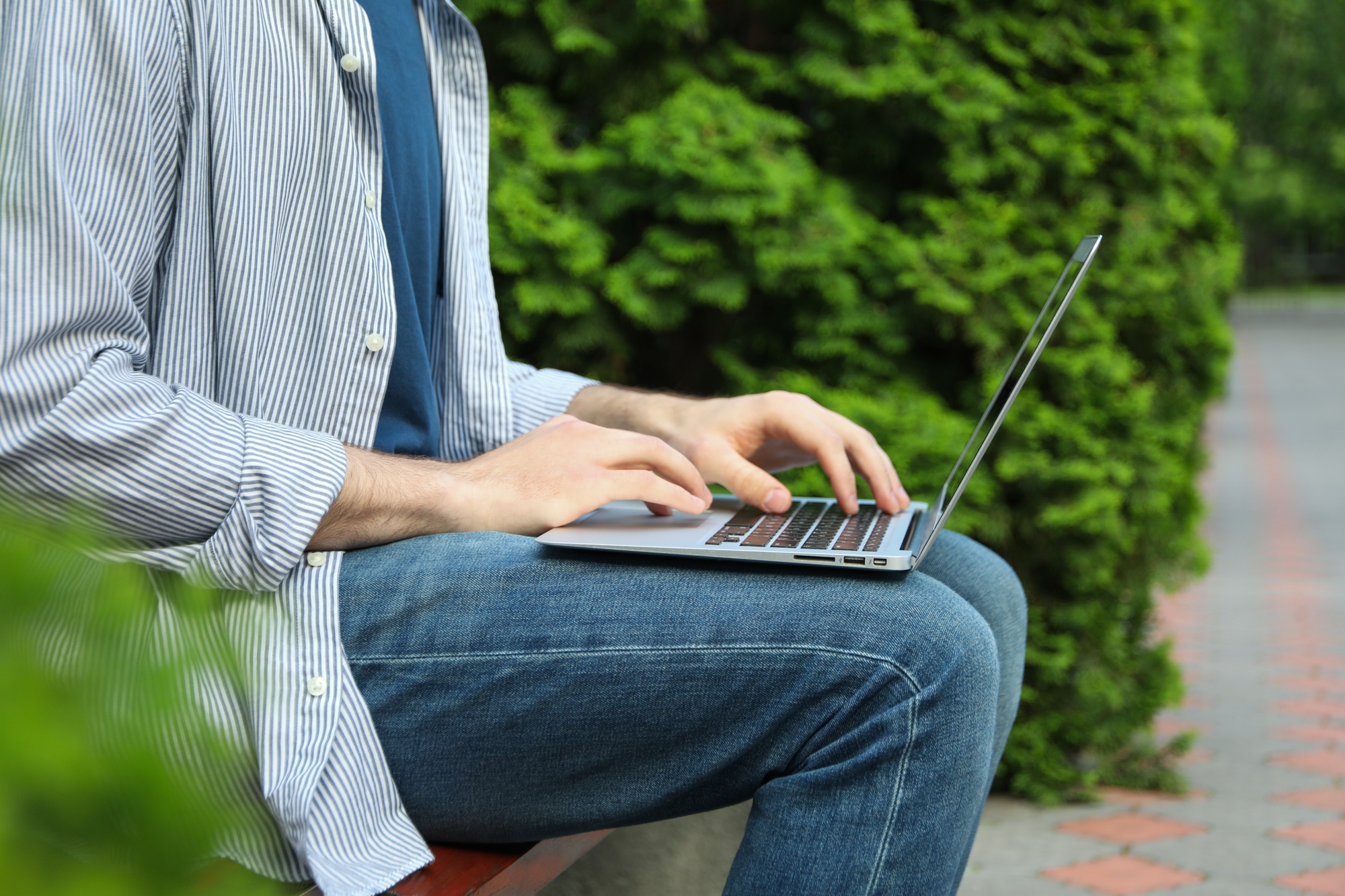 Young student working in a laptop outdoor. Study. University